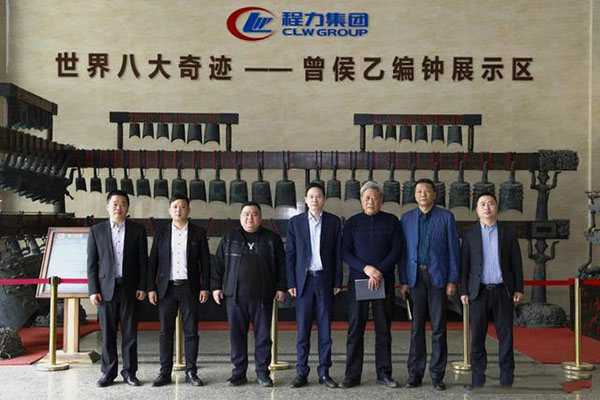 在程力汽車集團總部迎賓大廳，雙方代表觀摩世界八大奇跡編鐘后合影紀(jì)念